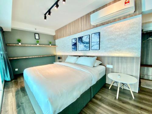 a bedroom with a large bed and a table at Maritime Suite #Full Seaview #Pool Table #Hot Water Dispenser #Kids friendly #Georgetown #6pax #2BR2bath #Private host in Jelutong