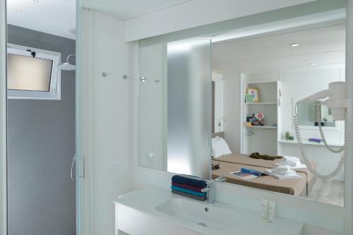 a white bathroom with a sink and a mirror at hu Roma Camping In Town in Rome