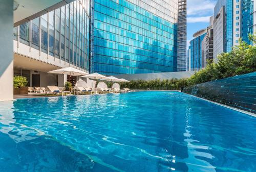 a large swimming pool in front of a building at Ascott Bonifacio Global City Manila in Manila