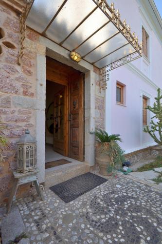 an entrance to a building with a wooden door at Archontiko Art Hotel in Galaxidhion