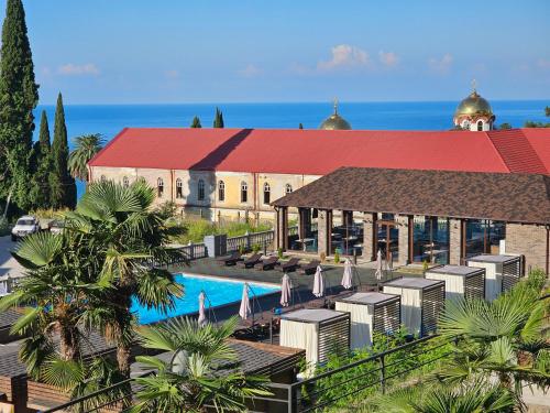 a resort with a swimming pool and a building at SkyTerra Park Hotel in Novy Afon