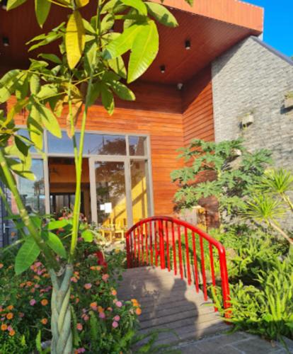 a red bench in front of a house at An Nhiên Villa in Bao Loc