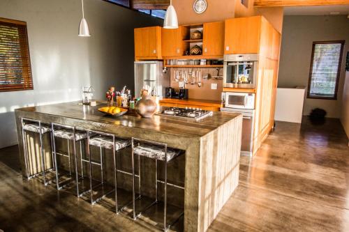 a kitchen with a large island in the middle of a room at Ongoye View Residence - Mtunzini in Mtunzini