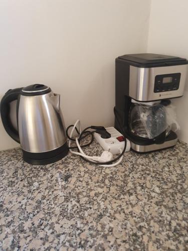 a coffee maker and a microwave on a counter at Appartement in Oujda