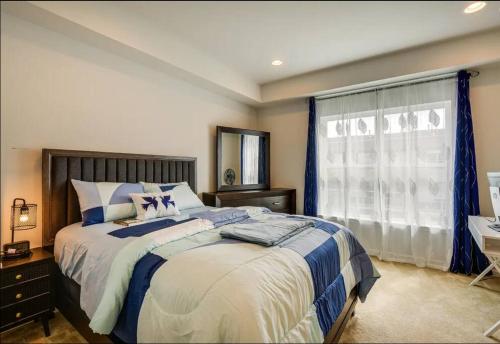 a bedroom with a large bed and a window at Stunning four-bedroom town home in Millersville