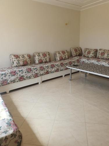 a waiting room with a long couch in a room at Appartement in Oujda