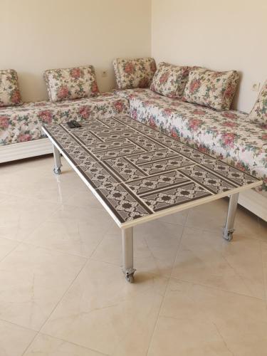 a coffee table in a living room with a couch at Appartement in Oujda