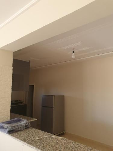 a kitchen with a white ceiling and a refrigerator at Appartement in Oujda