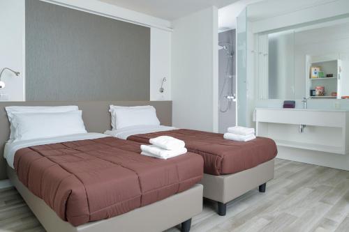 a bedroom with two beds and a bathroom with a shower at hu Roma Camping In Town in Rome