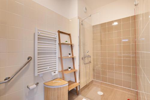 a bathroom with a shower and a toilet and a sink at Zenao Appart'hôtels Le Raincy in Le Raincy