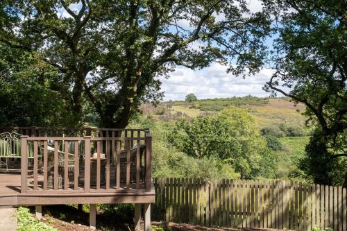 a wooden bench sitting next to a wooden fence at The Lookout in Fritham