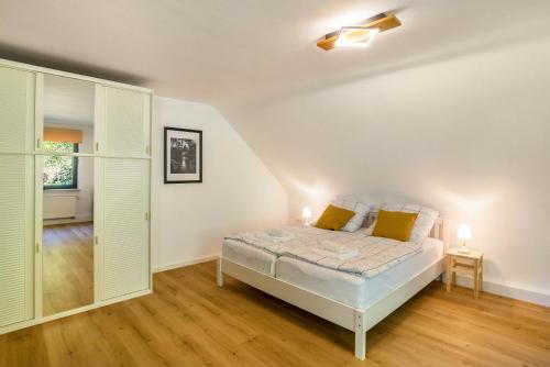 a bedroom with a bed with yellow pillows at Ferienwohnung Zur frischen Quelle in EuÃŸerthal