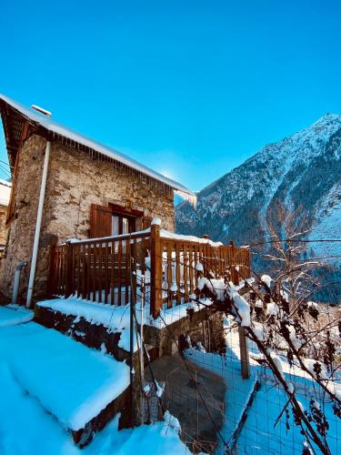 a snow covered house with a wooden fence at Kerbihan in Vénosc