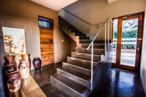a staircase in a house with vases next to it at Ongoye View Residence - Mtunzini in Mtunzini
