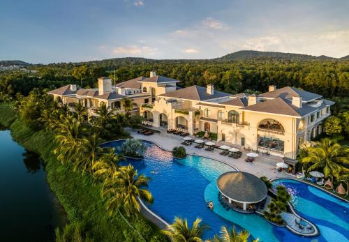 an aerial view of a large mansion with a swimming pool at Vinpearl Wonderworld Phu Quoc in Phú Quốc