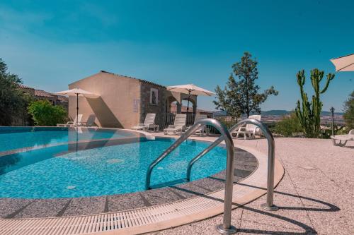 a swimming pool with a metal rail around it at The Fantastic Residenza Badus two bedroom sleeps six plus child num0818 in Badesi