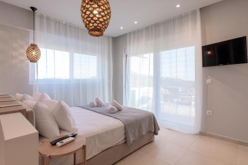 a bedroom with a bed and a large window at Marsane Luxury Appartments in Faliraki