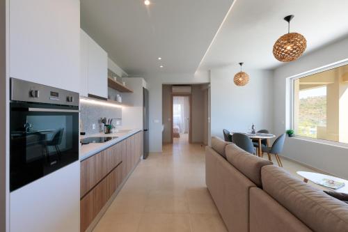 a kitchen and living room with a couch and a table at Marsane Luxury Appartments in Faliraki