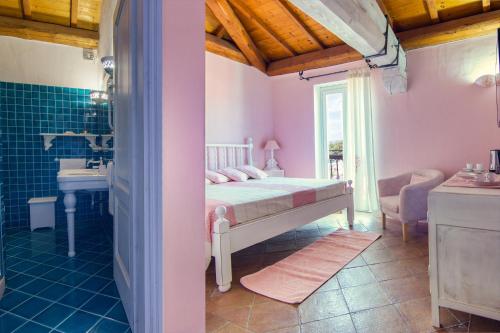 a bedroom with a bed and a bathroom with a sink at Domus Corallia-Luxury Rooms in Porto Rotondo