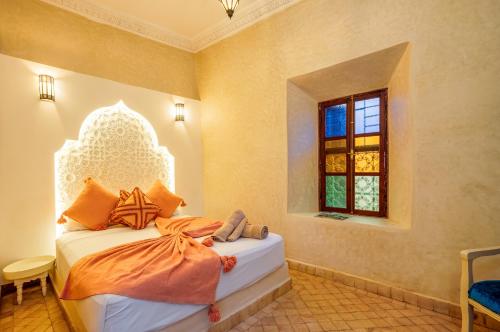 a bedroom with a bed and a window at Riad Privé Dar L'Étoile - Piscine & Petit Déj & dîner offert à partir de 4 nuits in Marrakesh