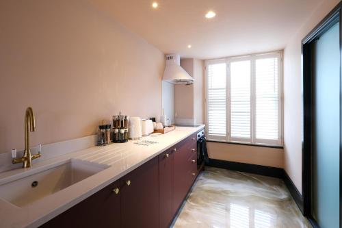 a kitchen with a large sink and a large window at Craig Walk Suite in Bowness-on-Windermere