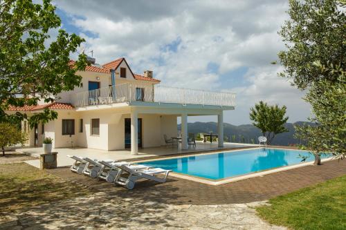 a villa with a swimming pool and a house at LuimarVenue in Pano Lefkara