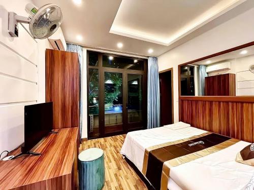 a bedroom with a bed and a flat screen tv at Dai Thanh Motel in Hanoi