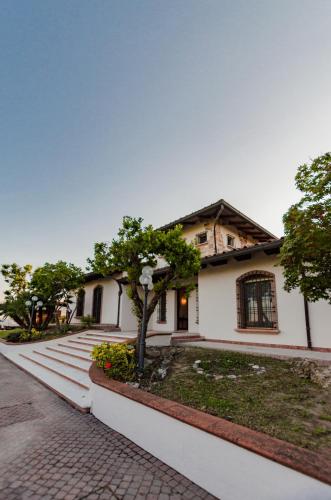 a white house with a tree in front of it at AMNESIA VILLAS in Borghetto