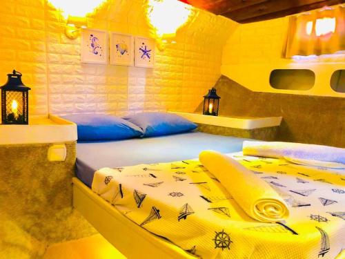 2 letti in una camera con pareti gialle di emir timur a Ortaca