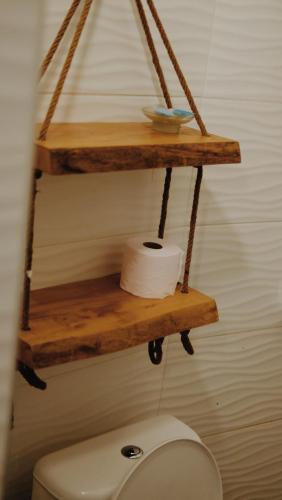a shelf above a toilet in a bathroom at At Pikotiko's - Korca City Rooms for Rent in Korçë