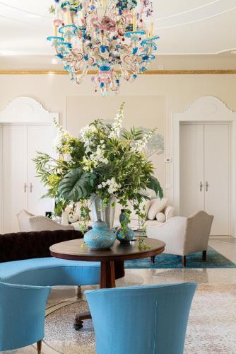 a living room with a table and a chandelier at Castello di Buttrio in Buttrio