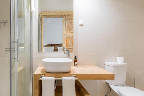 a bathroom with a sink and a toilet and a shower at Rabaçal Nature Spot Cottage in Estreito da Calheta