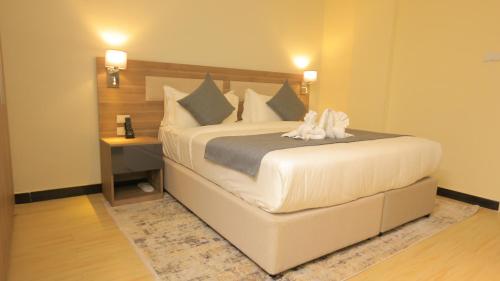 Postel nebo postele na pokoji v ubytování Triple E Hotel and Spa
