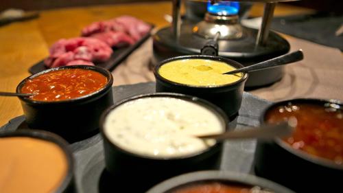 a tray of different types of food on a table at Gasthof Pension Madseiterhof in Tux