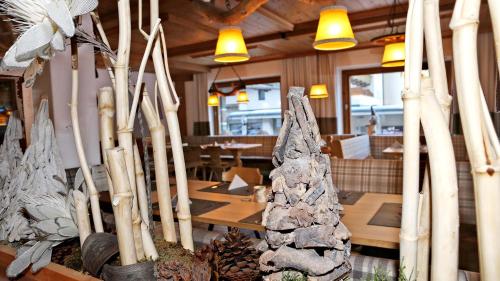 a restaurant with a table and some trees and lights at Gasthof Pension Madseiterhof in Tux
