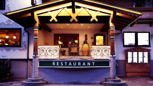 a restaurant sign on the front of a building at Gasthof Pension Madseiterhof in Tux
