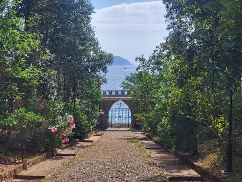 a pathway leading to a gate in a garden at Appartamento Mare Blu in Cavo