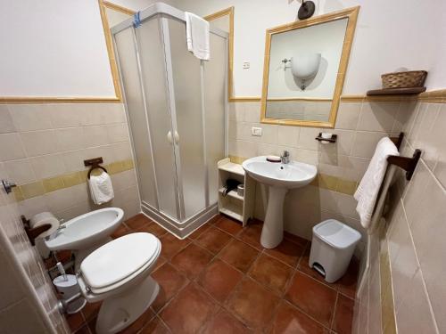 a bathroom with a toilet and a sink and a shower at Agriturismo Le Folaghe in Terracina