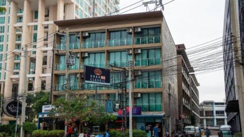 a large building with a sign in front of it at GranDE Classic Pattaya in North Pattaya