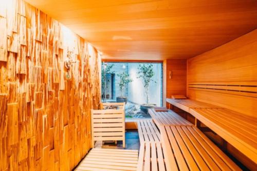 an empty sauna with wooden walls and wooden benches at Cosy, stylish new flat with spa and gym & shuttle to ski lifts in Laax