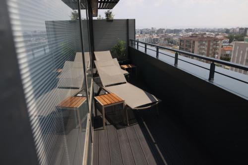 a balcony with two benches on a building at Best Western Premier Karsiyaka Convention & Spa Hotel in Izmir