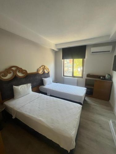 a hotel room with two beds and a window at Gala Otel Edirne in Edirne