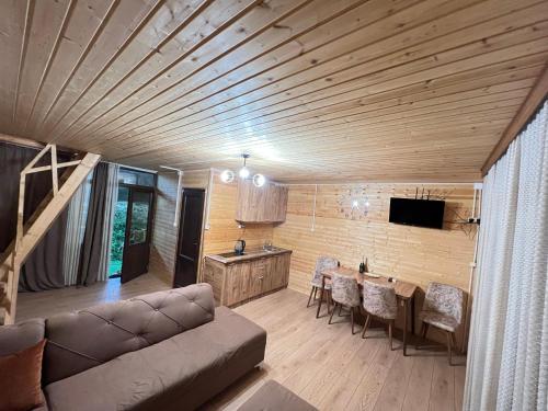 a living room with a couch and a table at Time House in Kokotauri