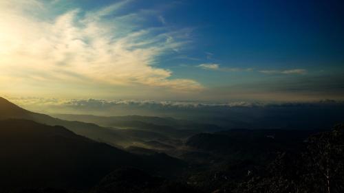 a view of a mountain valley with a cloudy sky at Nature Zone Jungle Resort in Munnar