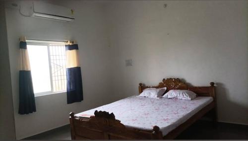 a bedroom with a wooden bed with a window at Hotel Ashirwad Palace in Rajaun