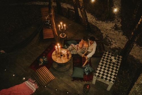 a man sitting at a table with a birthday cake at Jurty z widokiem, prywatna balia- DZIKOLAS GLAMPING in Krasnobród