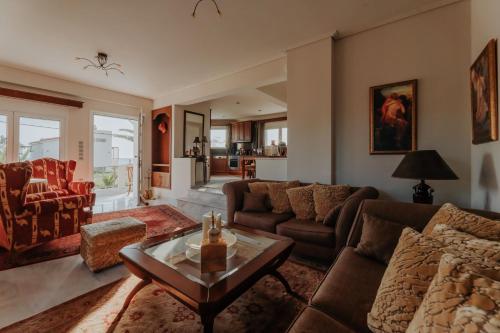 a living room with a couch and a table at Ponte Suites in Antirrio