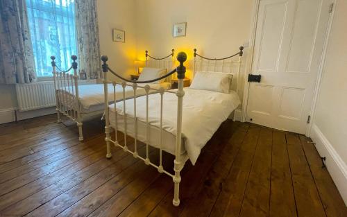 a bedroom with two beds and a window at Deerness, 4star gold award 2024, Whitby in Whitby