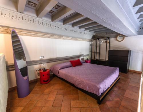 a bedroom with a purple bed in a room at Fabroniana Apartments in Pistoia