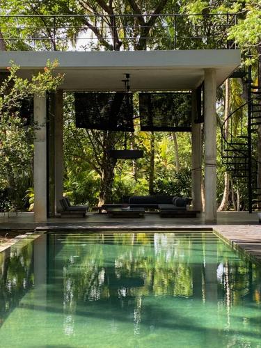 a swimming pool in a house with a pavilion at KAJU GREEN eco lodges in Unawatuna